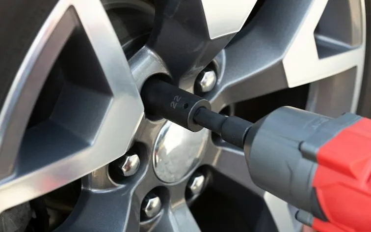 hands checking a tyre — common MOT fail points