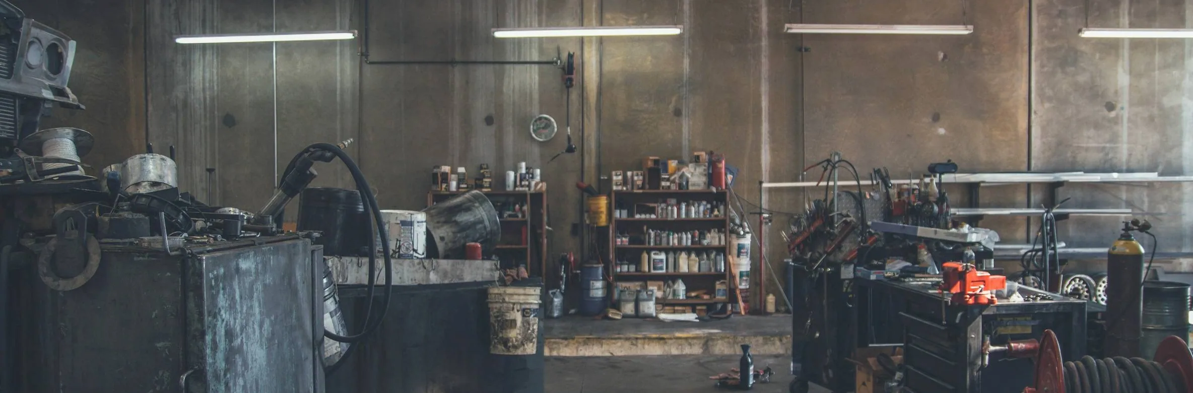 a dark, moody workshop scene, wide