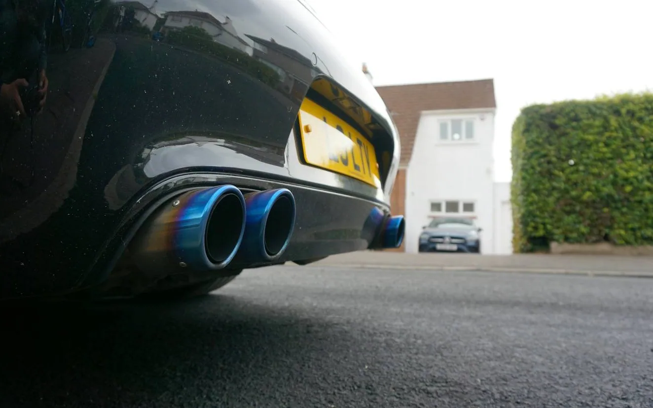 an exhaust tailpipe on a UK car, close — MOT retest
