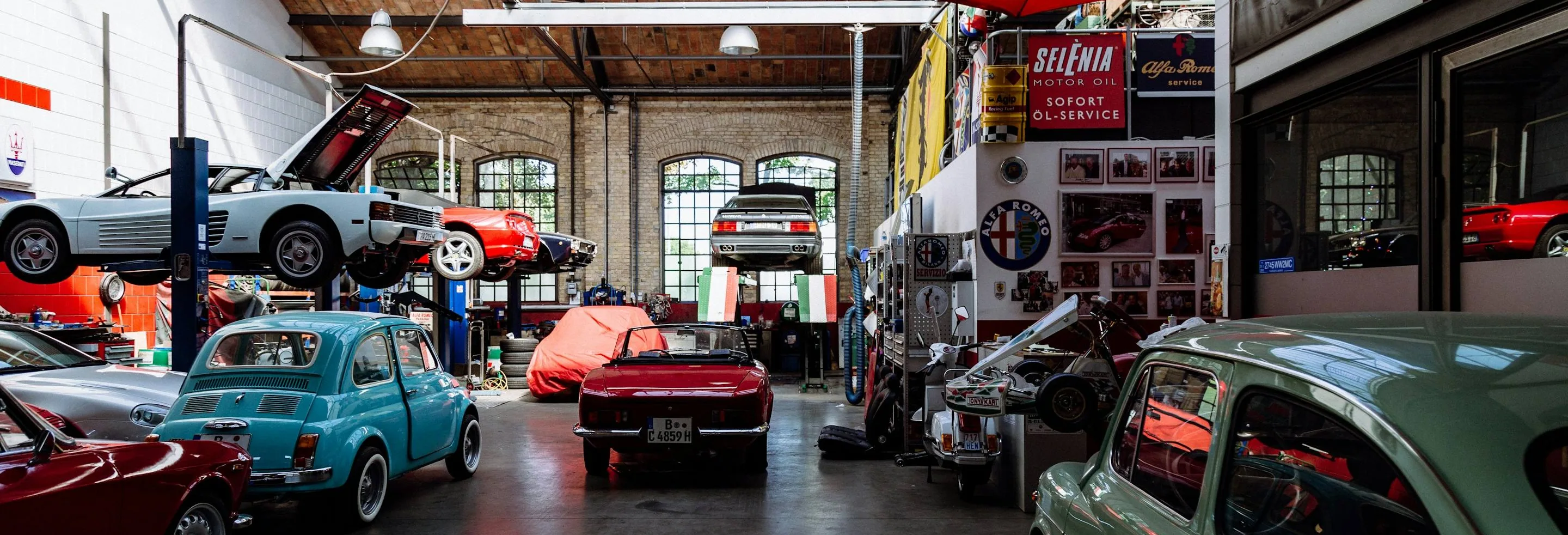 a workshop with cars in for work, wide
