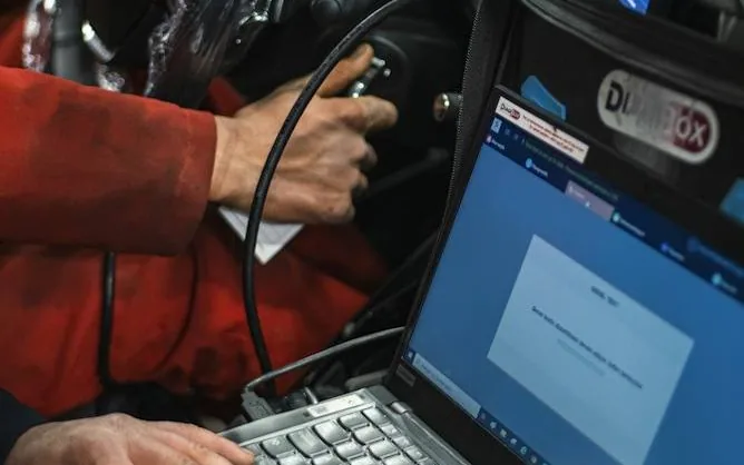 diagnostics — laptop or OBD reader plugged into a car