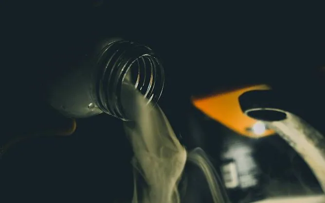 servicing — oil going in, hands only